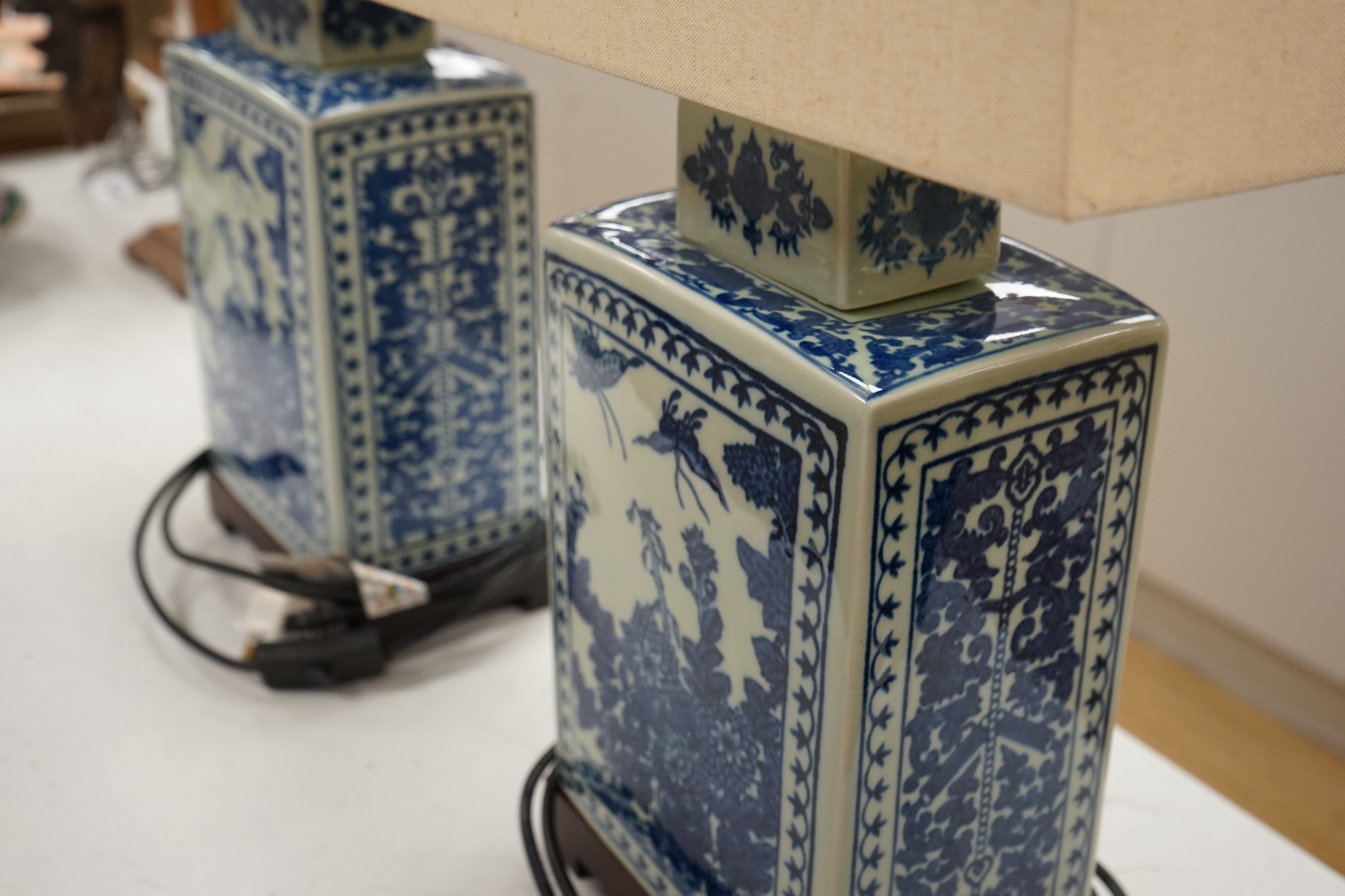 A pair of rectangular profile Japanese blue and white table lamps on stands, with shades, 59cm high. Condition - good